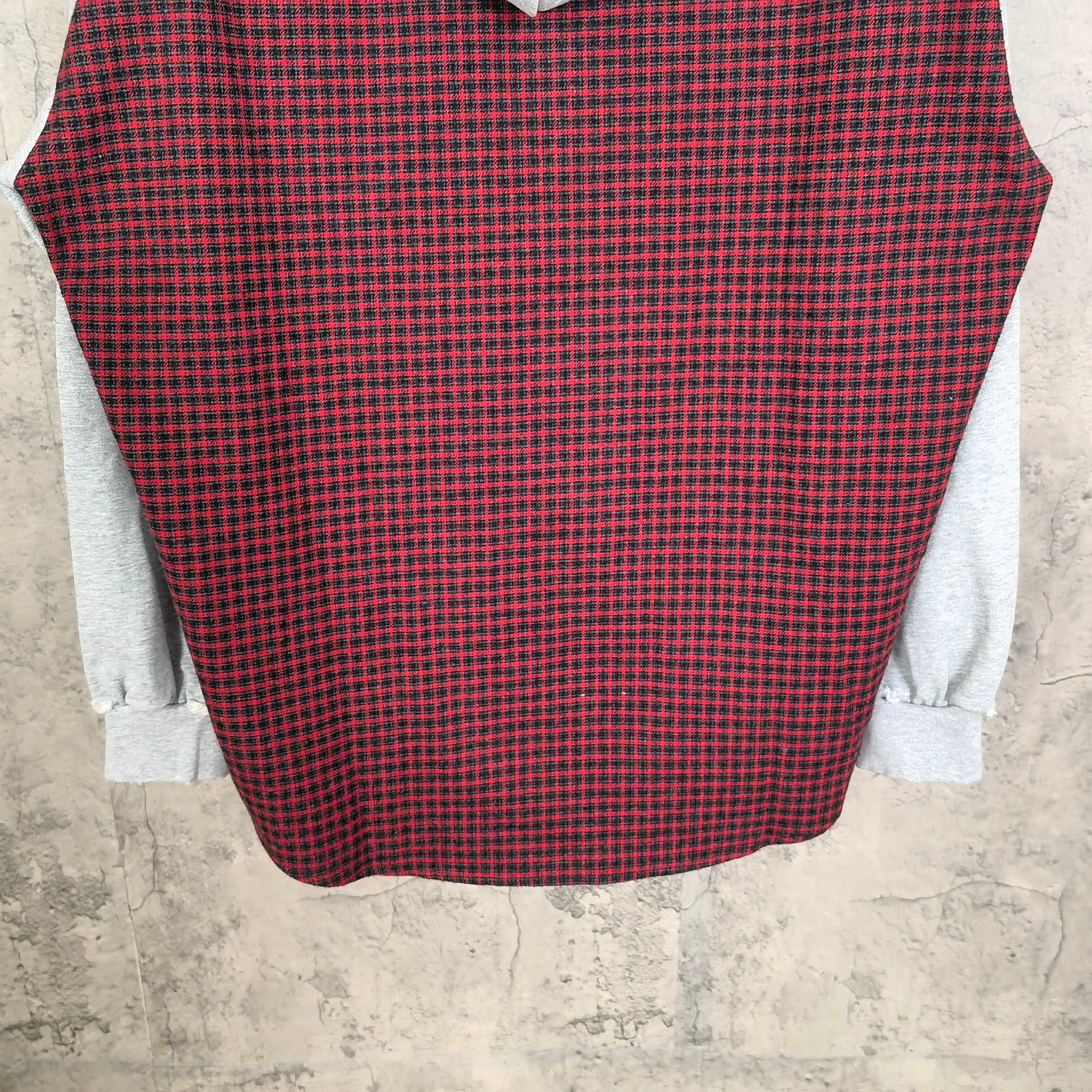 Long-sleeve plaid top in red and black with light gray sleeve cuffs