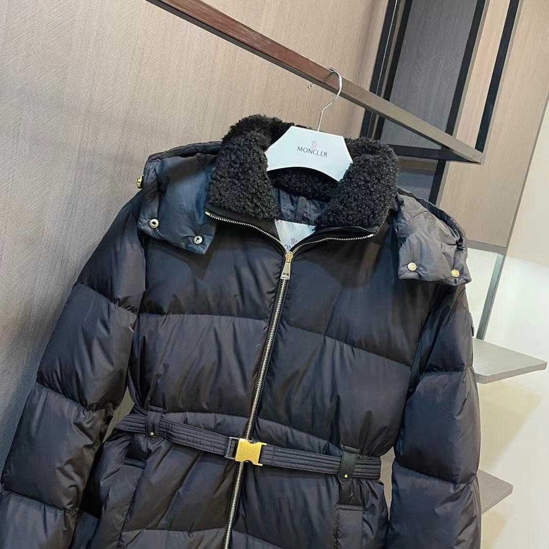 Long black puffer coat with dark fur collar and snap shoulder buttons