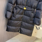 Long black puffer coat with wide belt and vertical front zipper