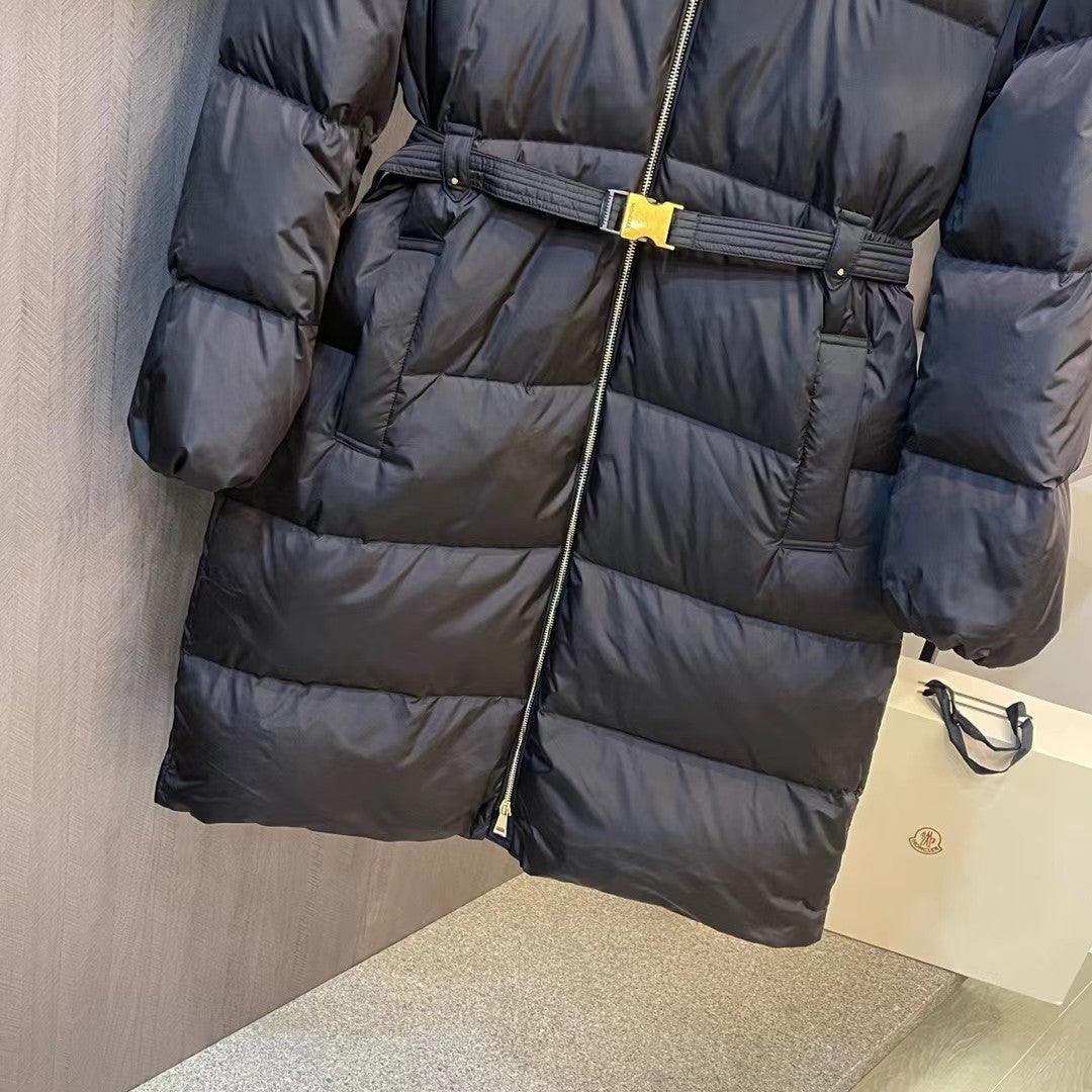 Long black puffer coat with wide belt and vertical front zipper