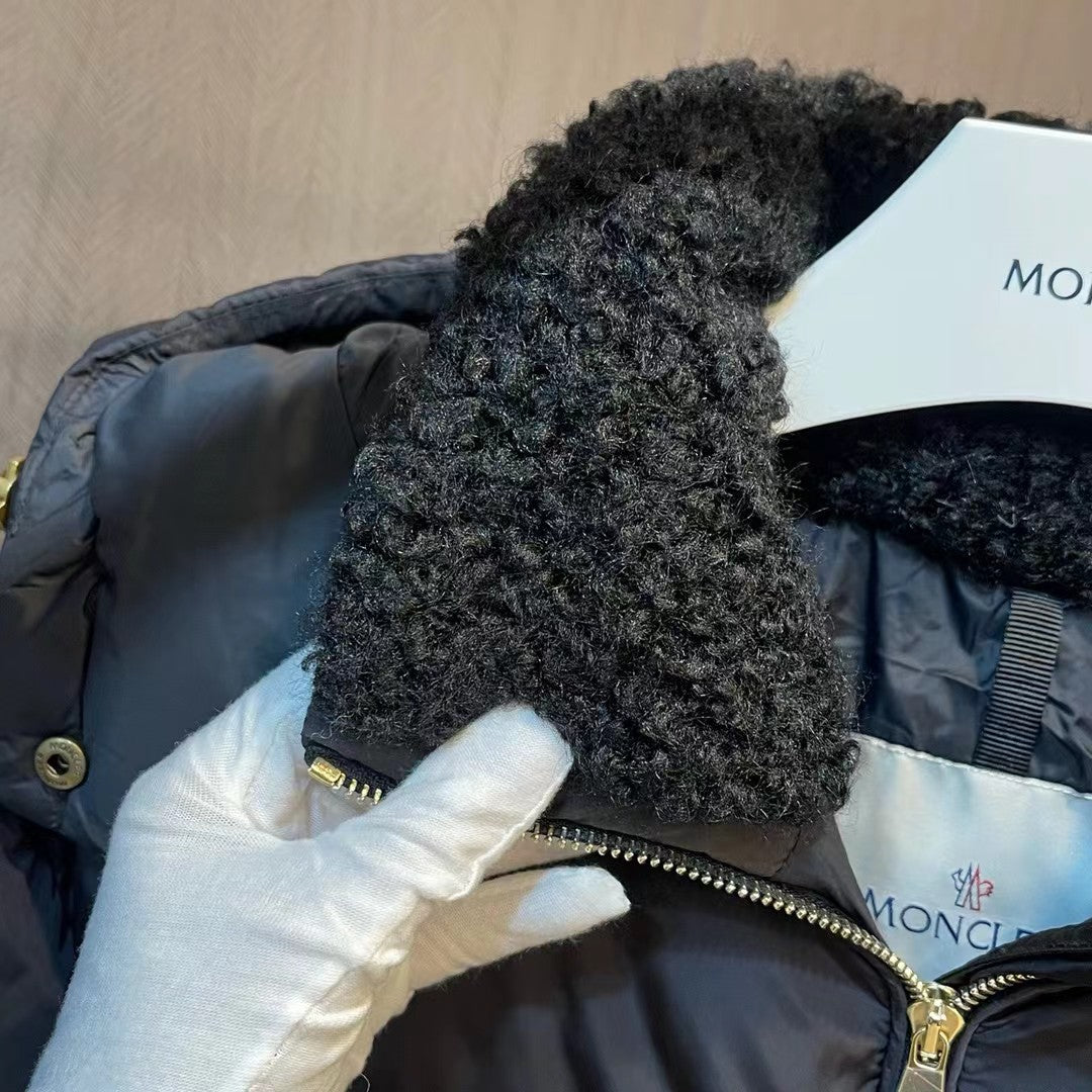 Faux-fur hood and front zipper on black puffer coat, with logo tag