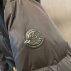 Moncler circular logo patch on dark puffer sleeve