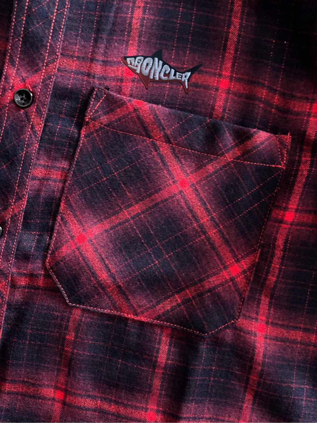Long-sleeve plaid shirt close-up, flap chest pocket with dark buttons