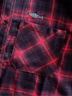 Long-sleeve plaid shirt close-up, flap chest pocket with dark buttons