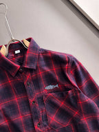 Long-sleeve plaid shirt close-up, red and dark blue, chest pocket and logo