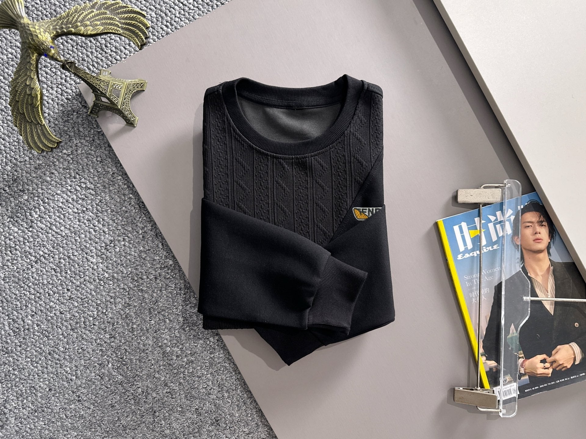 Fendi black long-sleeve sweatshirt on hanger, textured front panel and logo badge