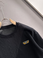 Fendi black long-sleeve sweatshirt close-up showing crew neck and logo patch