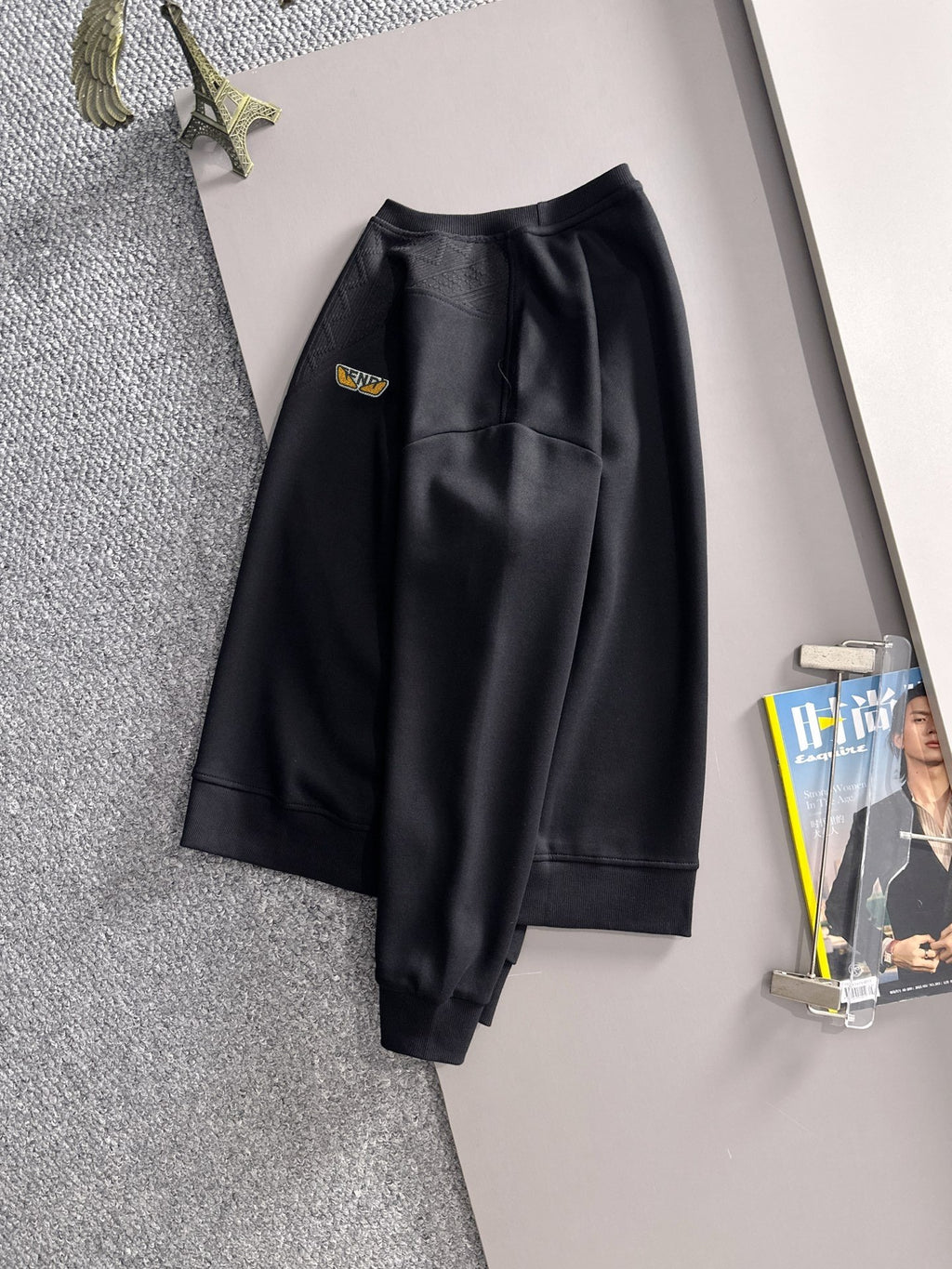 Fendi black long-sleeve sweatshirt with matching pants, both hanging on display