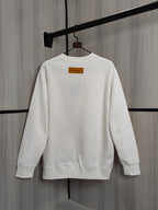 White crewneck sweatshirt back view on hanger with small orange label
