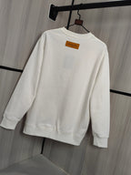White crewneck sweatshirt back view with orange neck label on hanger