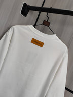 White crewneck sweatshirt with orange back neck label detail