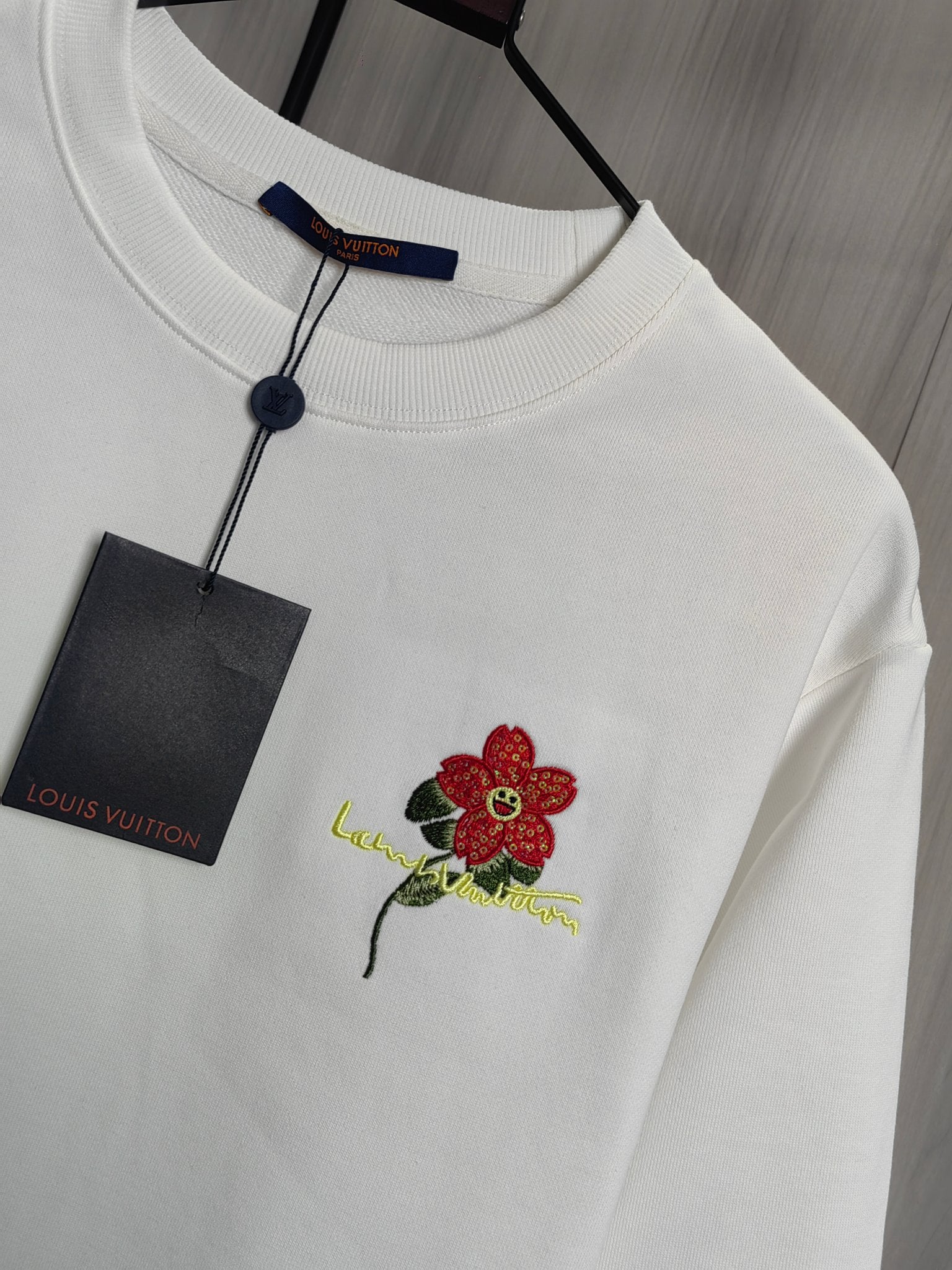 White crewneck sweatshirt with red flower embroidery and Louis Vuitton neck tag