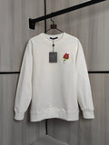 White crewneck sweatshirt with red flower patch and embroidered multicolor detail