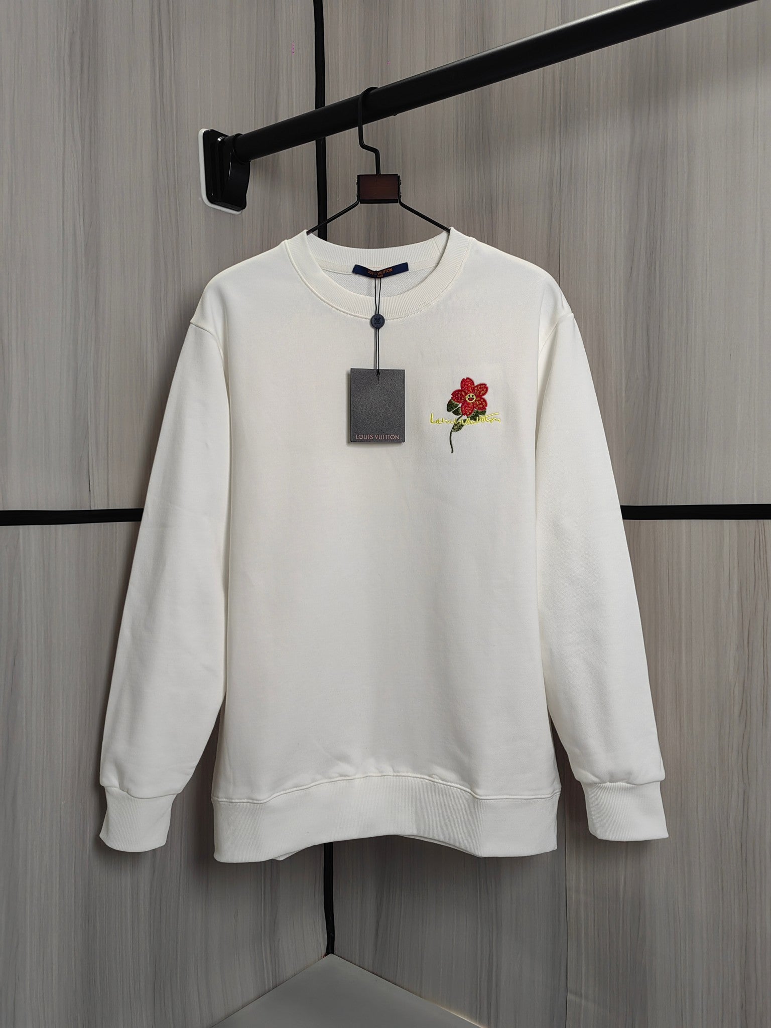 White crewneck sweatshirt with red flower patch and embroidered multicolor detail