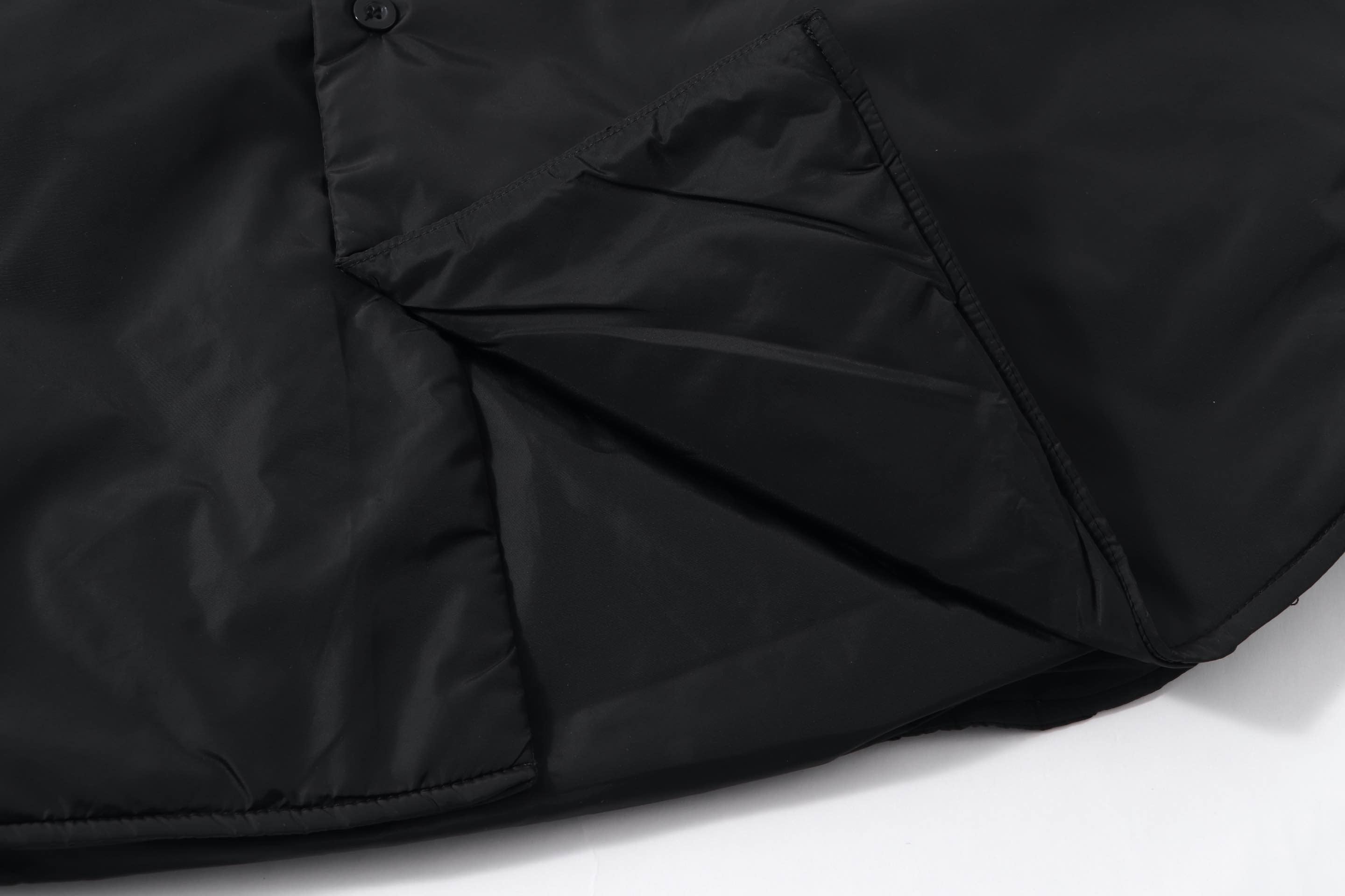 Black Prada shirt sleeve with diagonal stitched panel and button
