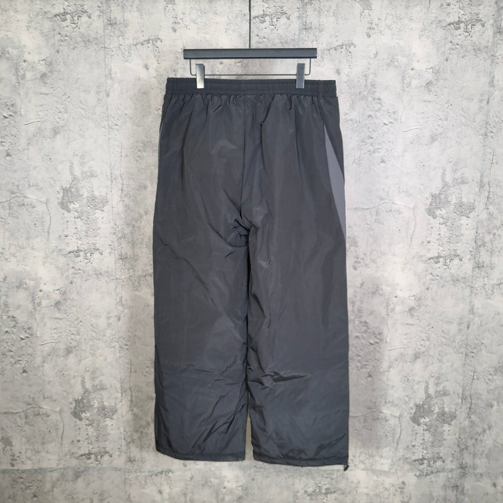 Black pants with elastic waist and gathered center seam; Balenciaga logo on leg