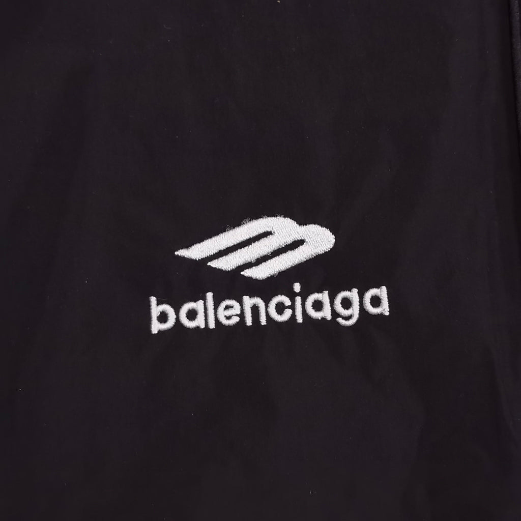Close-up of Balenciaga logo on black pants fabric