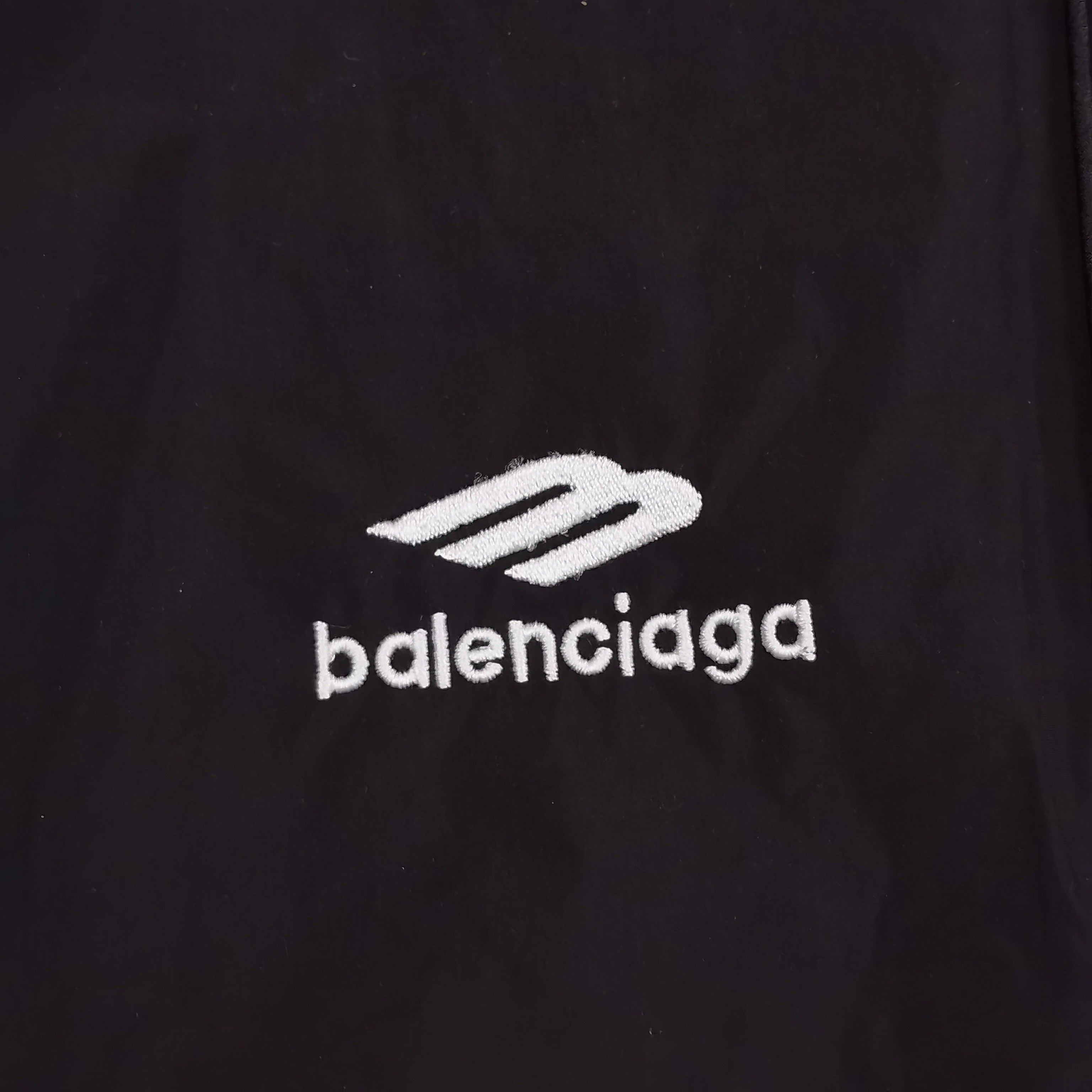 Close-up of Balenciaga logo on black pants fabric