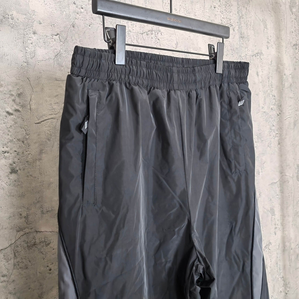 Black pants with ruched elastic waistband and side logo on leg