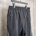 Black pants with ruched elastic waistband and side logo on leg