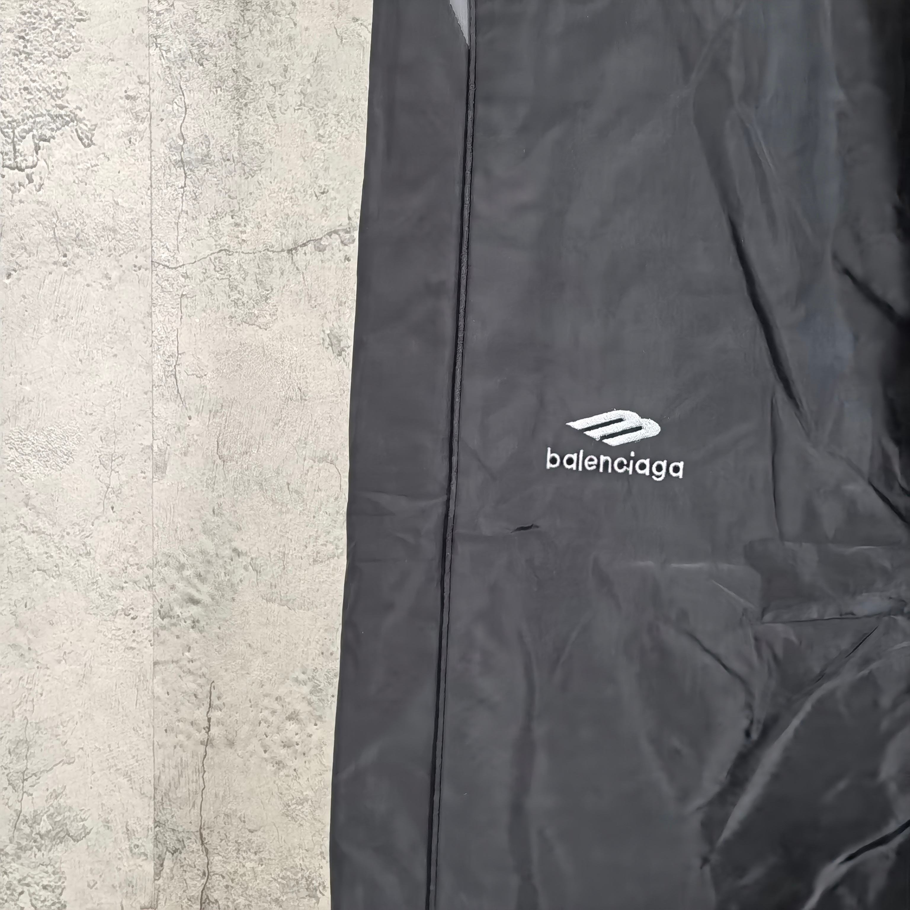 Black pants with side stripe seam and Balenciaga logo on leg