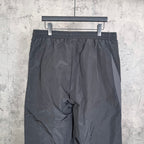 Black pants with elastic waistband and central seam detail