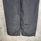 Dark gray Balenciaga track pants, front close-up with seams and gathered fabric