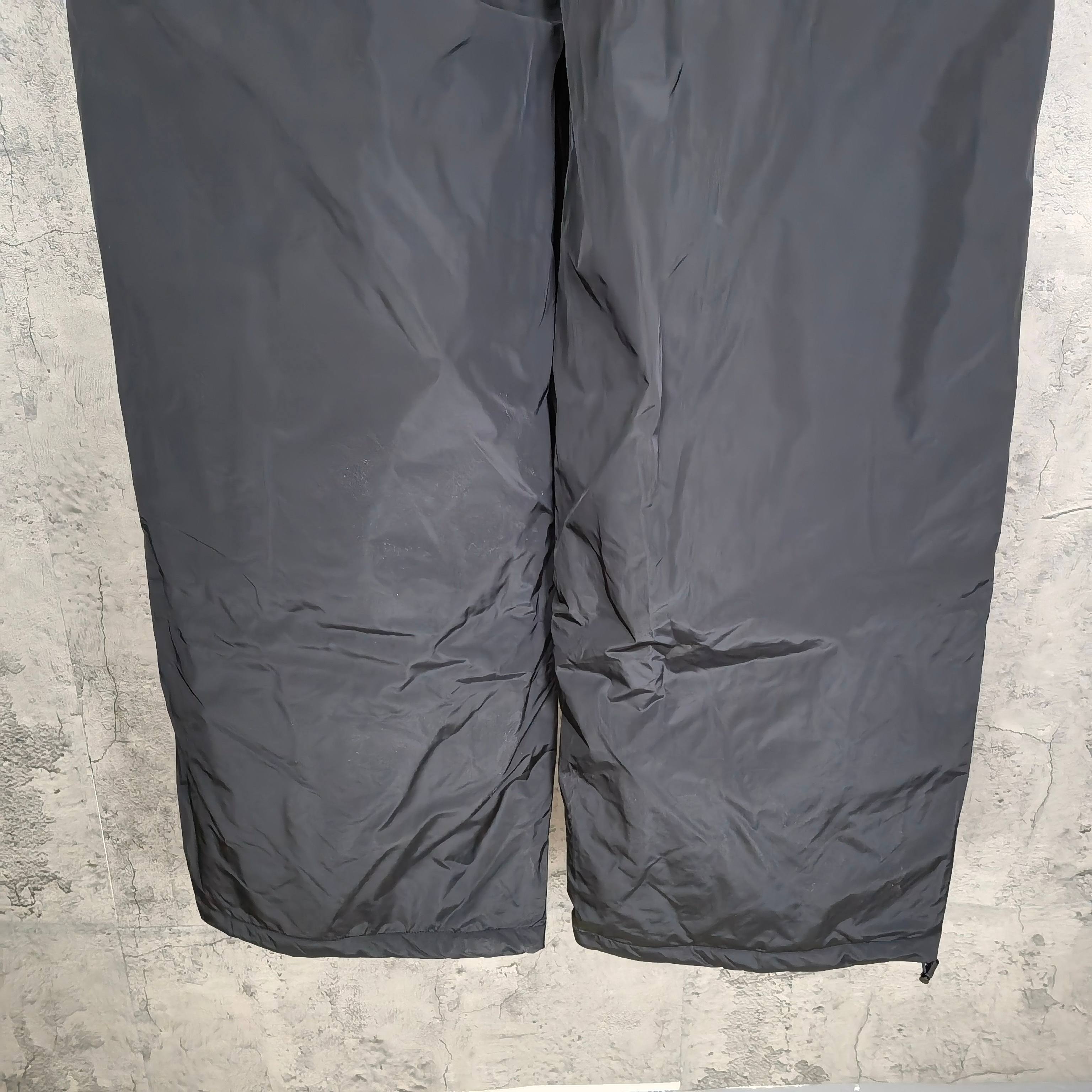 Dark gray Balenciaga track pants, front close-up with seams and gathered fabric