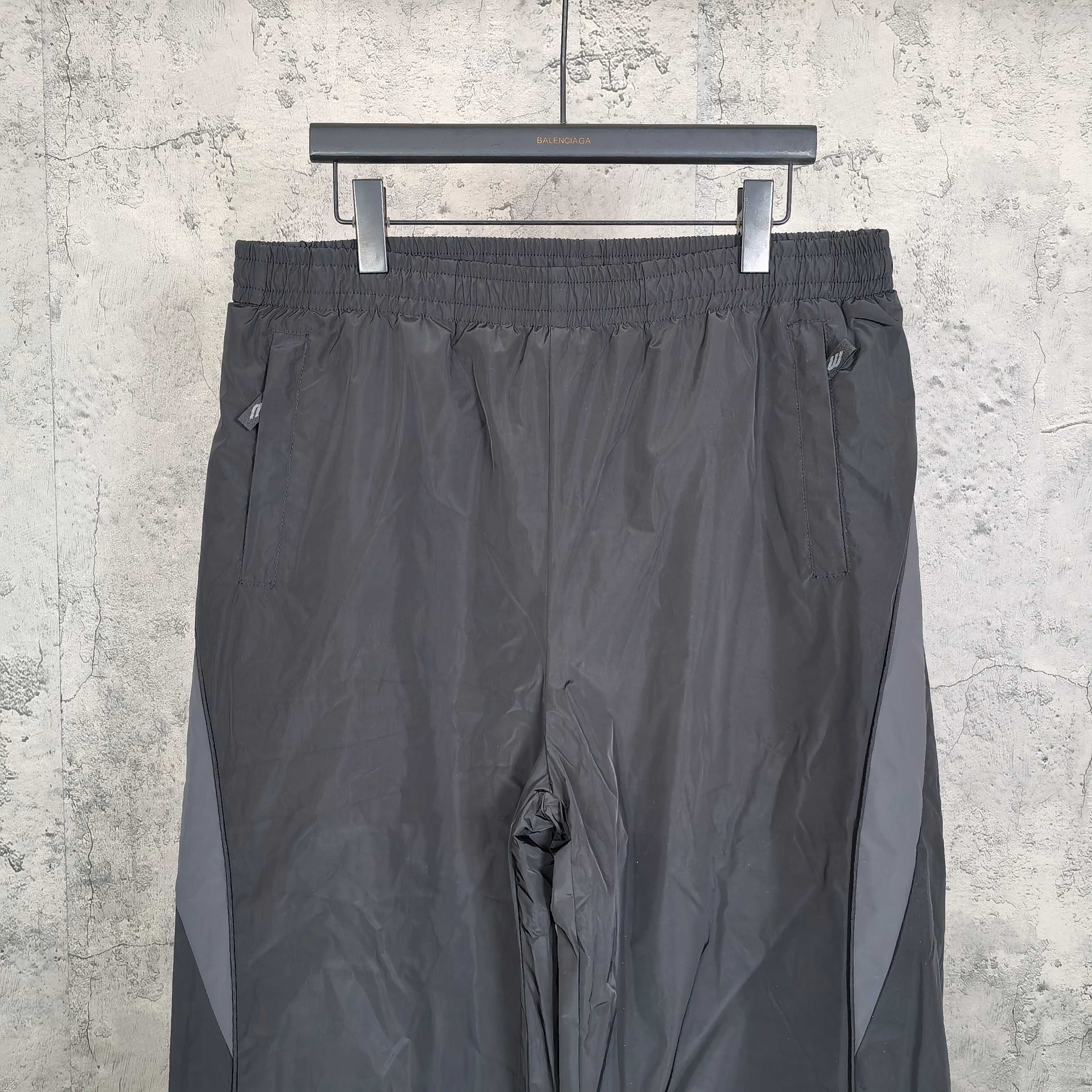 Dark gray Balenciaga track pants with elastic waistband and adjustable drawstring