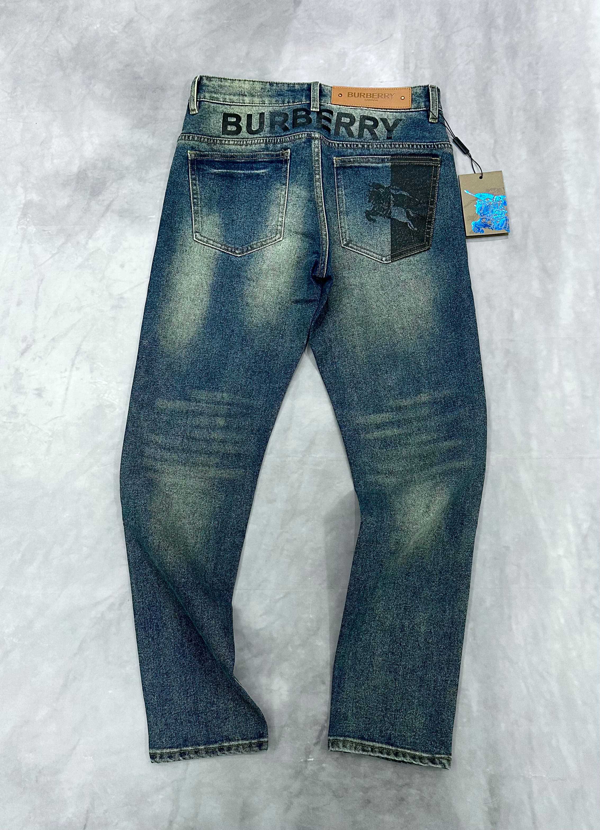 Burberry blue denim jeans, back view with belt loops and logo waistband