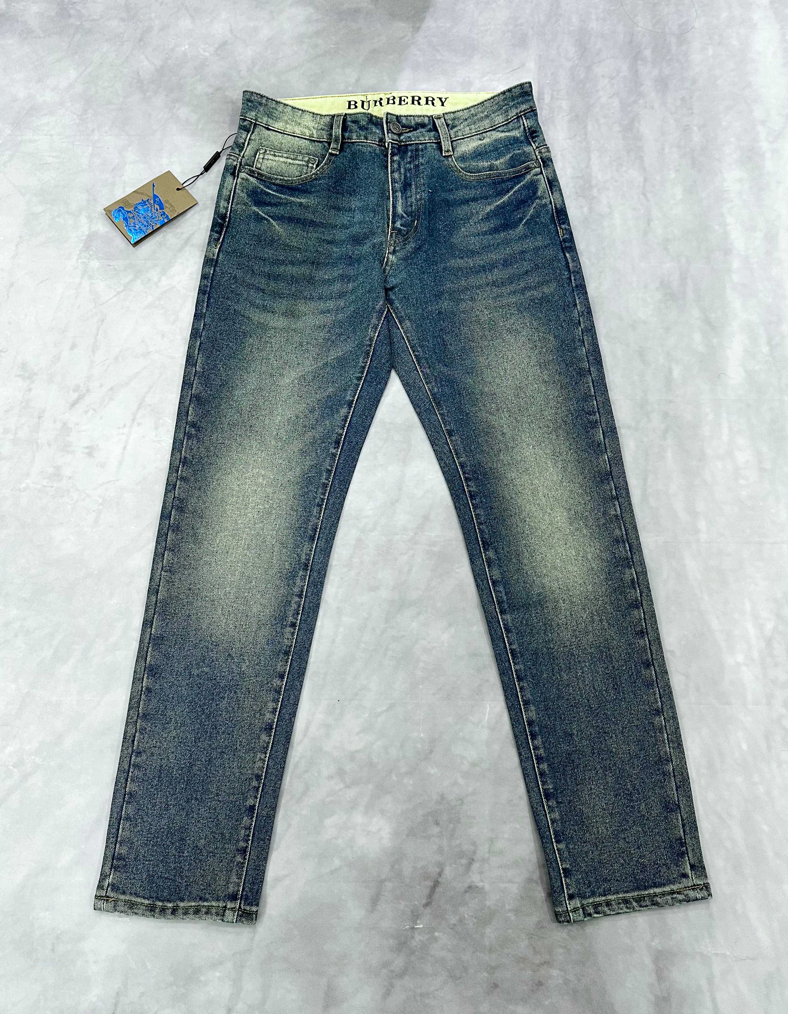 Burberry blue denim jeans with straight legs, button fly, and stitched seams