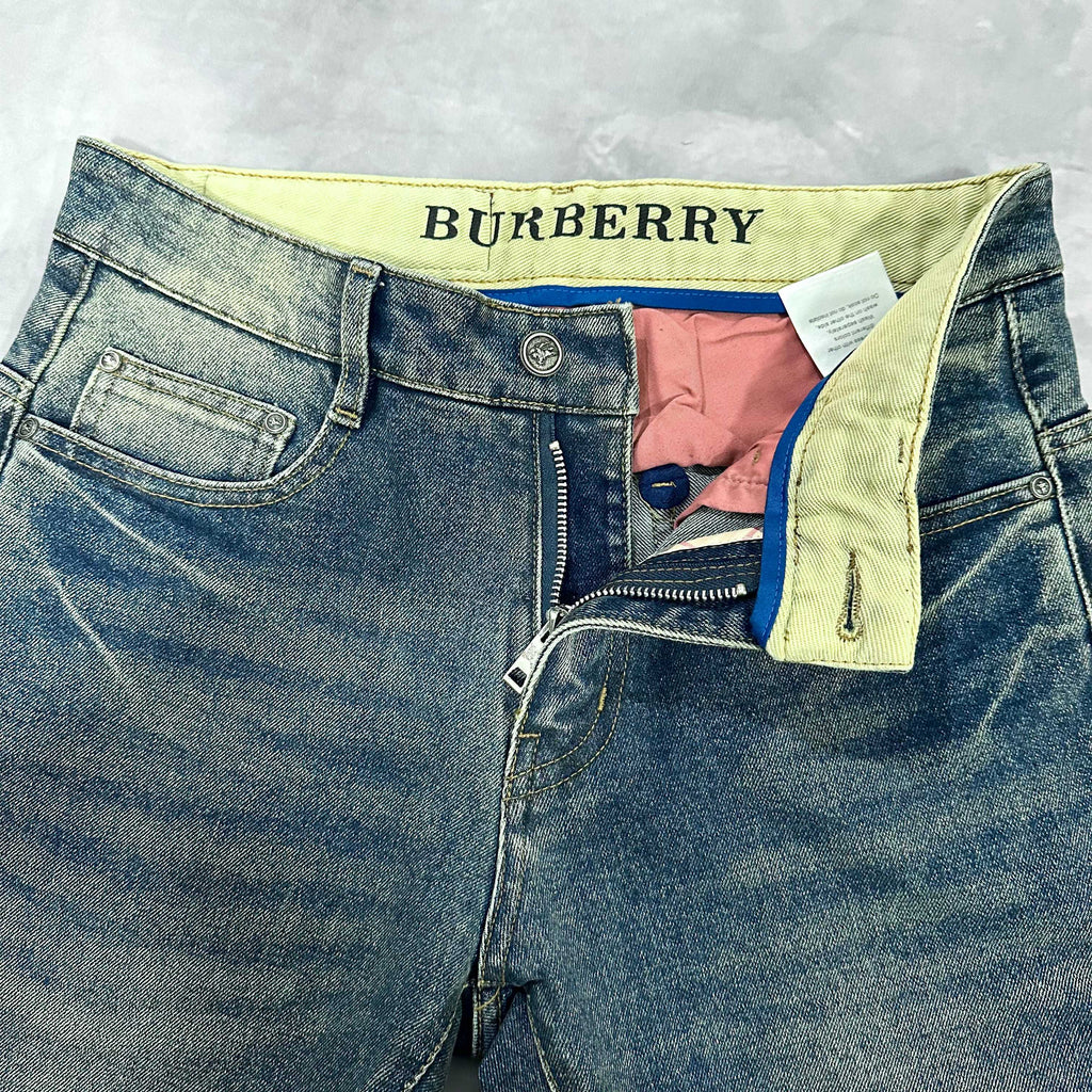 Burberry blue denim jeans with yellow waistband lining and visible inner tags