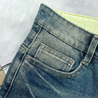 Burberry blue denim jeans close-up of waistband, button, and coin pocket