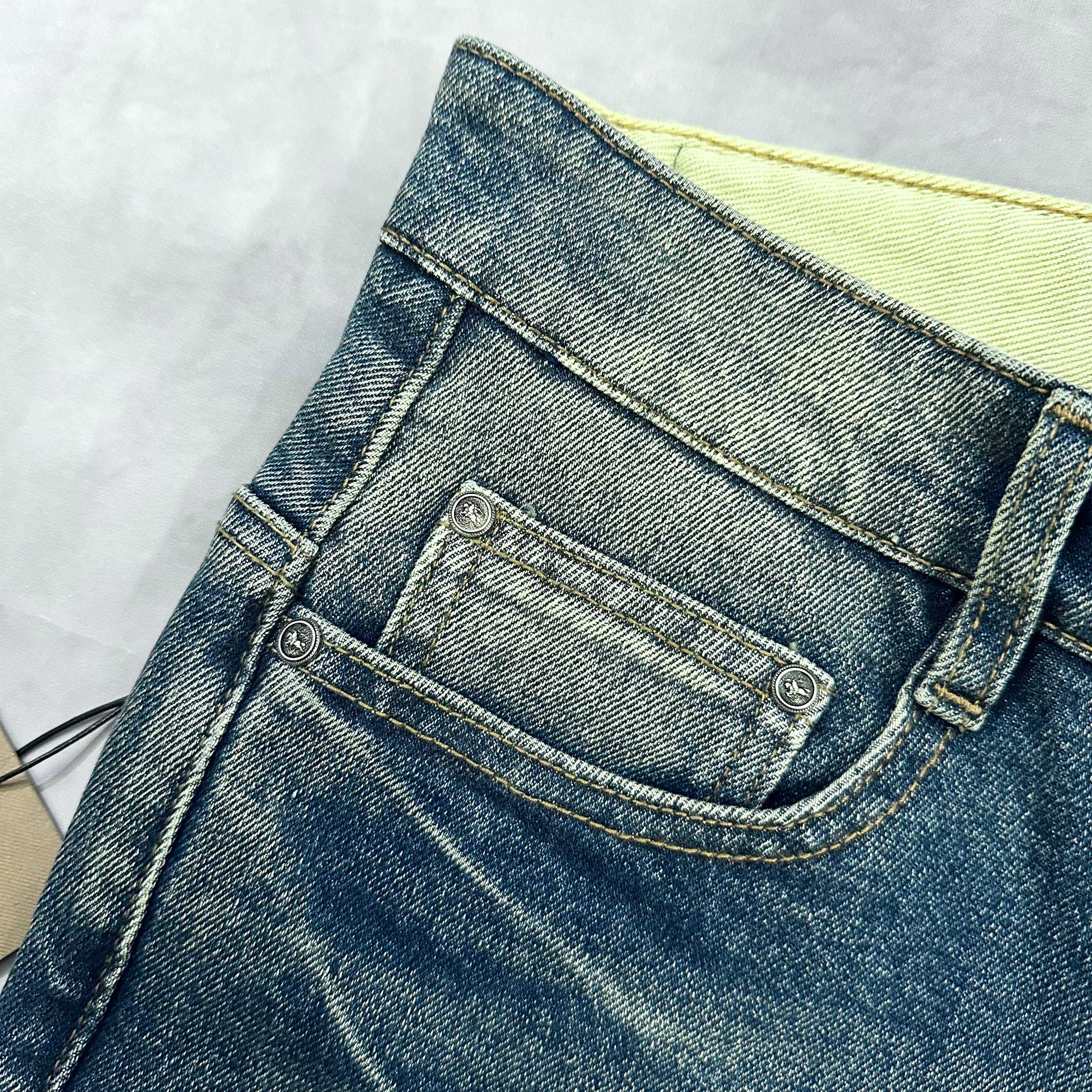 Burberry blue denim jeans close-up of waistband, button, and coin pocket
