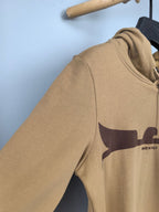 Tan hoodie sleeve and chest graphic panel, side view on hanger