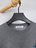 Dior long-sleeve crewneck sweatshirt neckline with brand label and heather gray fabric