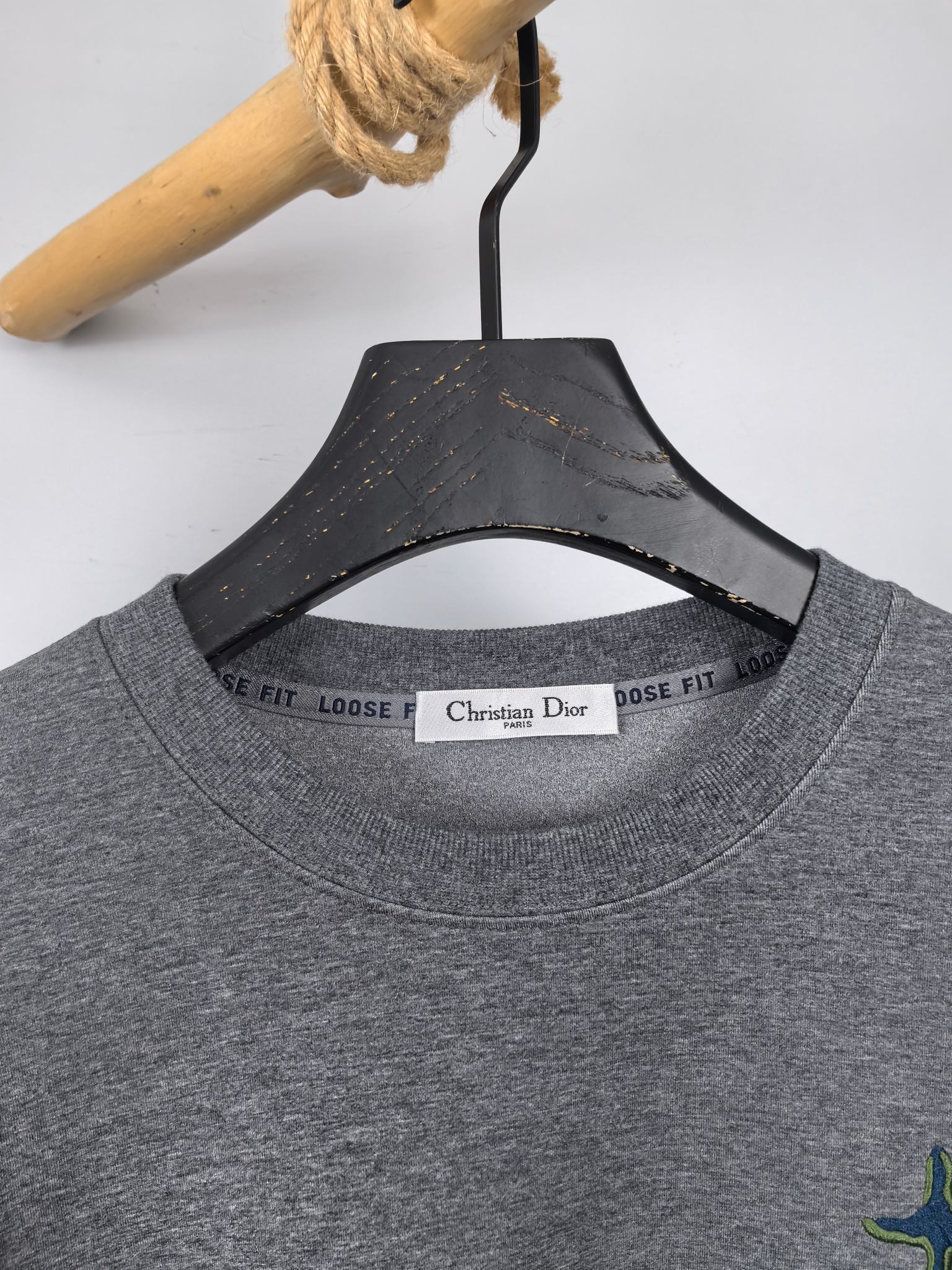 Dior long-sleeve crewneck sweatshirt neckline with brand label and heather gray fabric