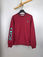 Red long-sleeve crewneck sweatshirt with turquoise cross logo on chest