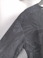 Long-sleeve sweatshirt sleeve with dark gray leaf print, crew neck edge.