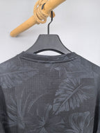 Long-sleeve sweatshirt with dark gray leaf print, crew neckline shown.