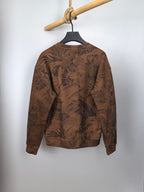 Brown long-sleeve sweatshirt with dark tropical leaf pattern and crew neck
