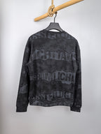 Dark gray crewneck sweatshirt with camo-style text graphic on the back