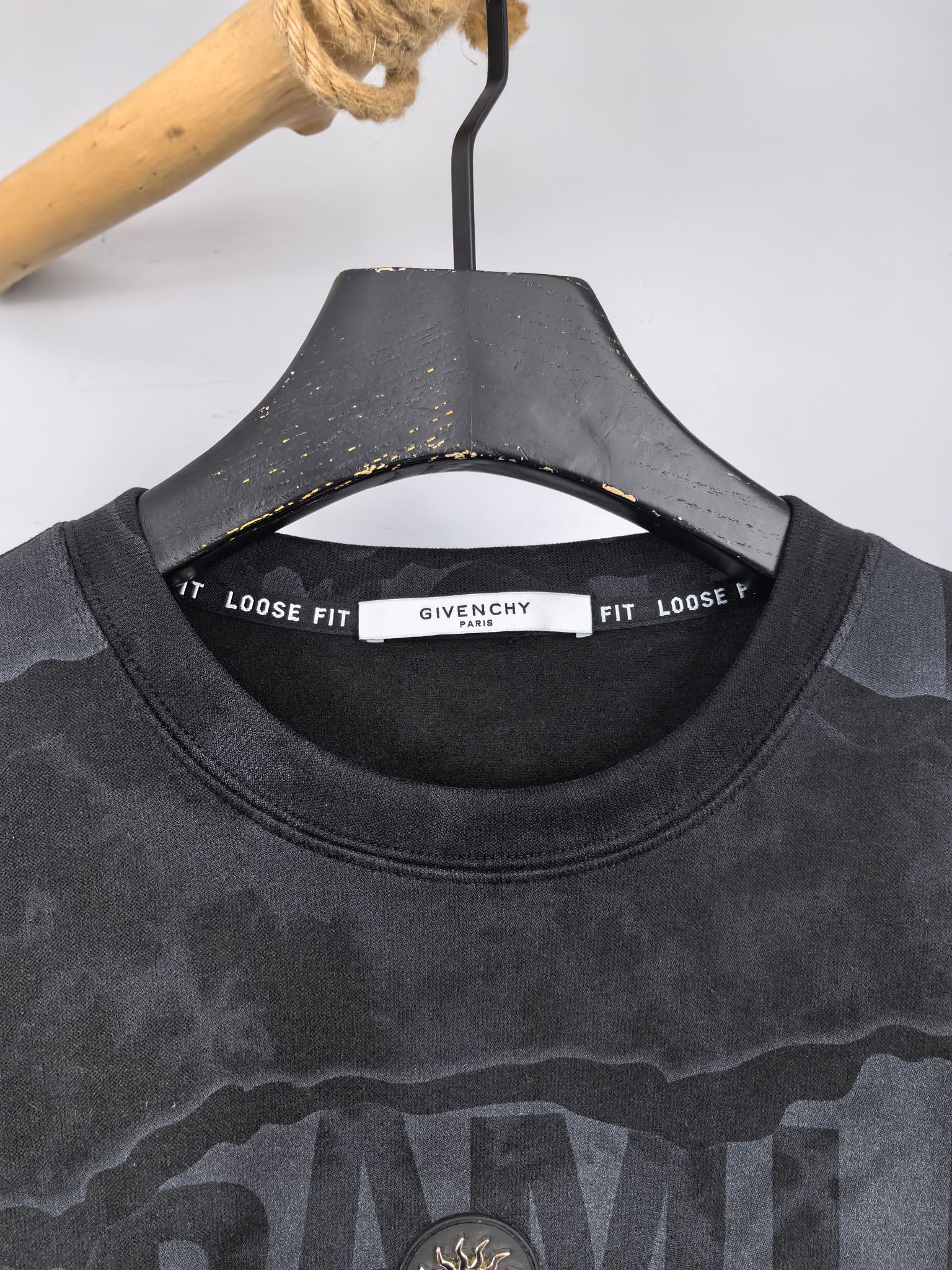 Crewneck sweatshirt neckline with interior brand label and ribbed collar