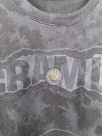 Dark gray crewneck sweatshirt with large front text graphic and round emblem detail