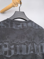 Dark gray crewneck sweatshirt back with camo-style text graphic near the shoulders