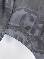 Dark gray crewneck sweatshirt lower sleeve and hem with large camo-style text