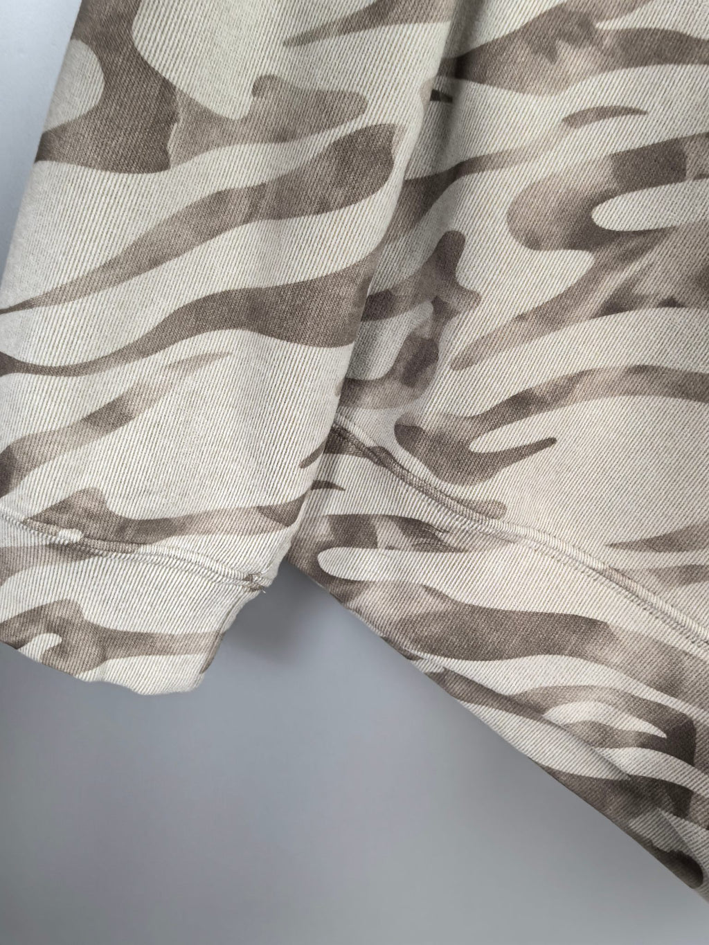 Camo crewneck sweatshirt fabric close-up, off-white and taupe