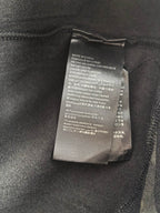 Interior care label on dark camo crewneck sweatshirt, fabric tag detail