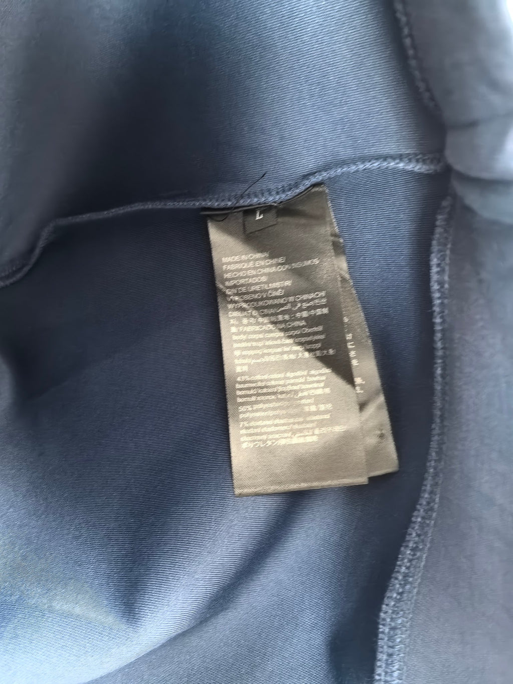 Blue Louis Vuitton crewneck sweatshirt with interior care label near collar