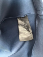 Blue Louis Vuitton crewneck sweatshirt with interior care label near collar